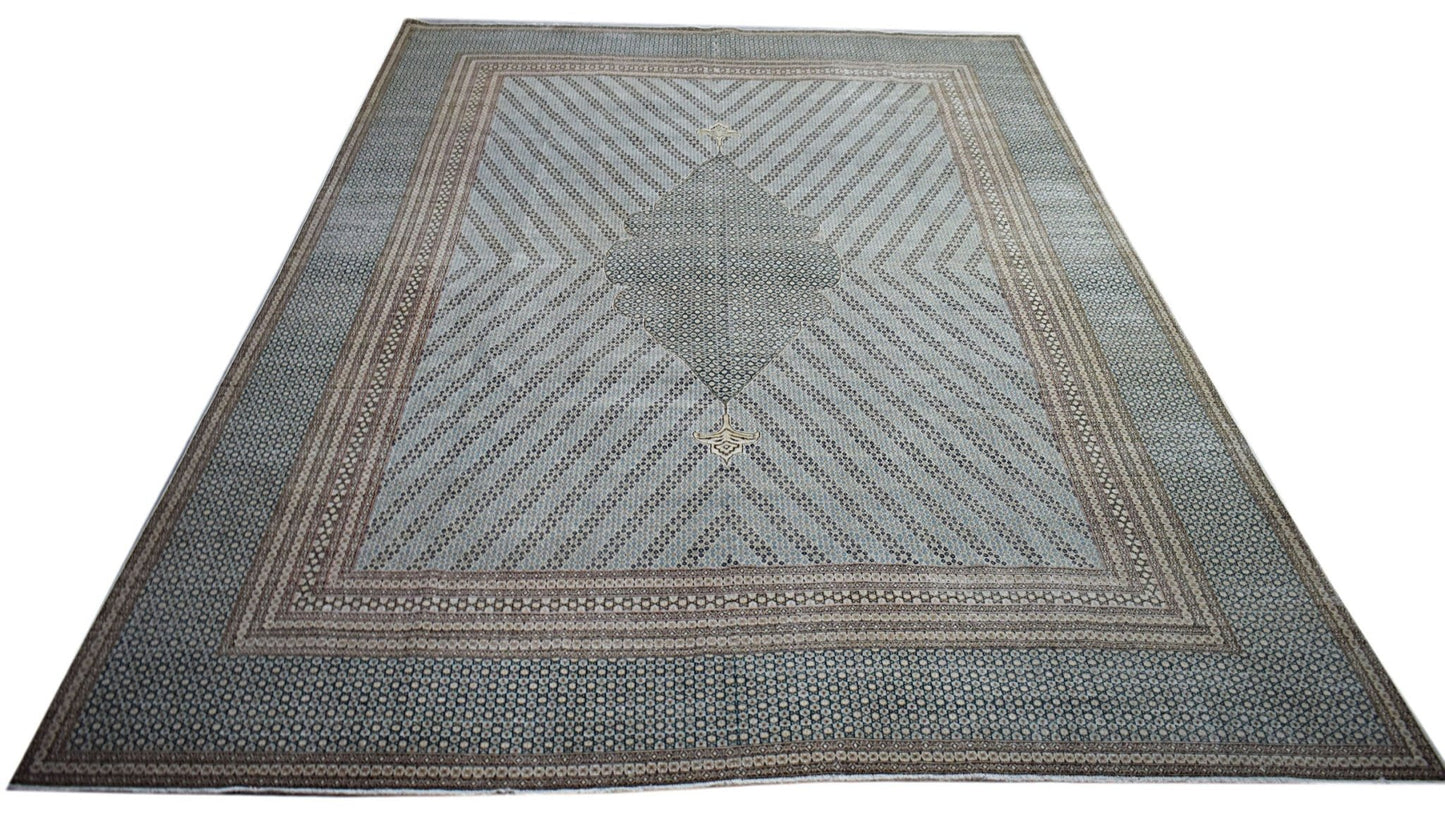 A vintage Persian Kerman rug featuring a central medallion and intricate geometric patterns.