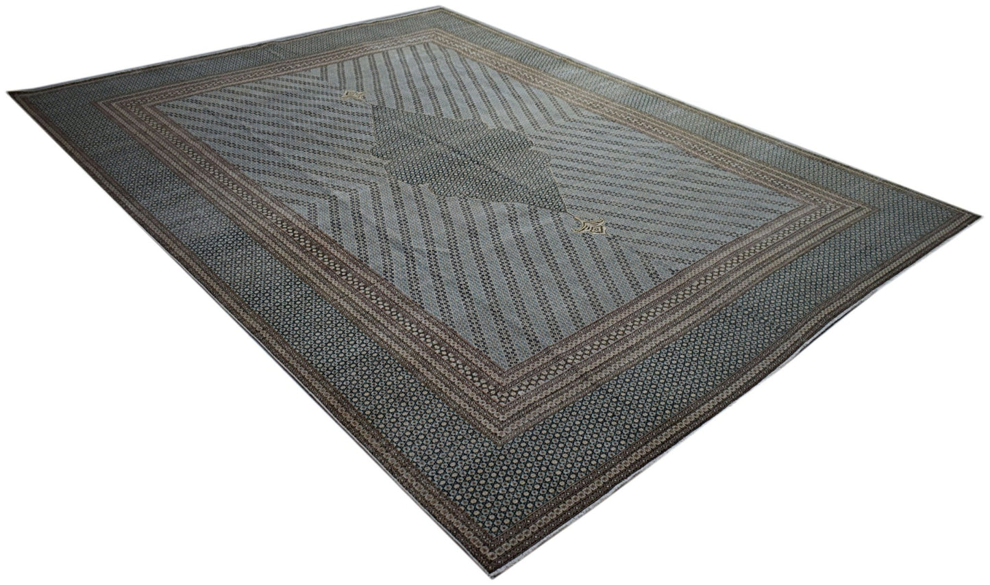 A vintage Persian Kerman rug featuring a central medallion and intricate geometric patterns.