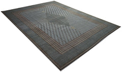 A vintage Persian Kerman rug featuring a central medallion and intricate geometric patterns.