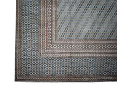 A vintage Persian Kerman rug featuring intricate geometric patterns in blue and beige tones.