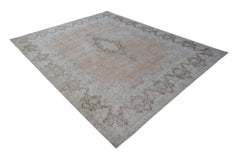 A vintage Persian Kerman rug featuring a central medallion and intricate floral border in soft tones.