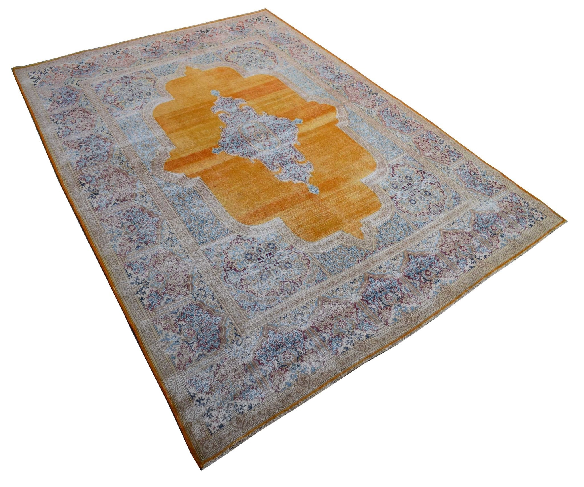 A vintage Persian Kerman rug featuring a central medallion on a vibrant orange field.