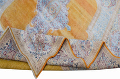 A vintage Persian Kerman rug featuring a golden yellow field with intricate blue floral patterns.