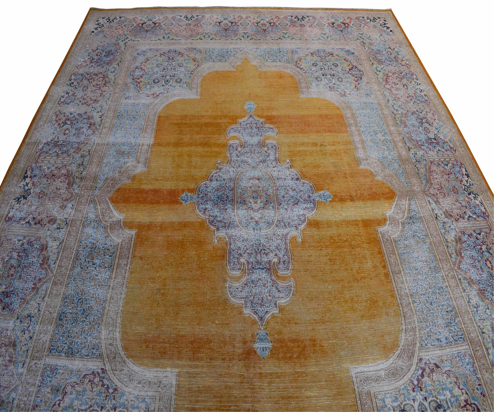 A vintage Persian Kerman rug featuring a central medallion on a golden field with floral borders.