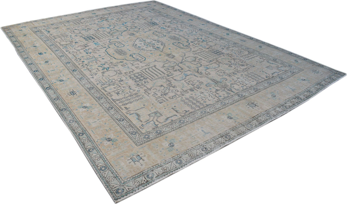 A vintage Persian Kerman rug featuring a central medallion and intricate floral patterns in blue.
