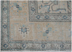 A vintage Persian Kerman rug featuring intricate blue and beige floral and geometric patterns.