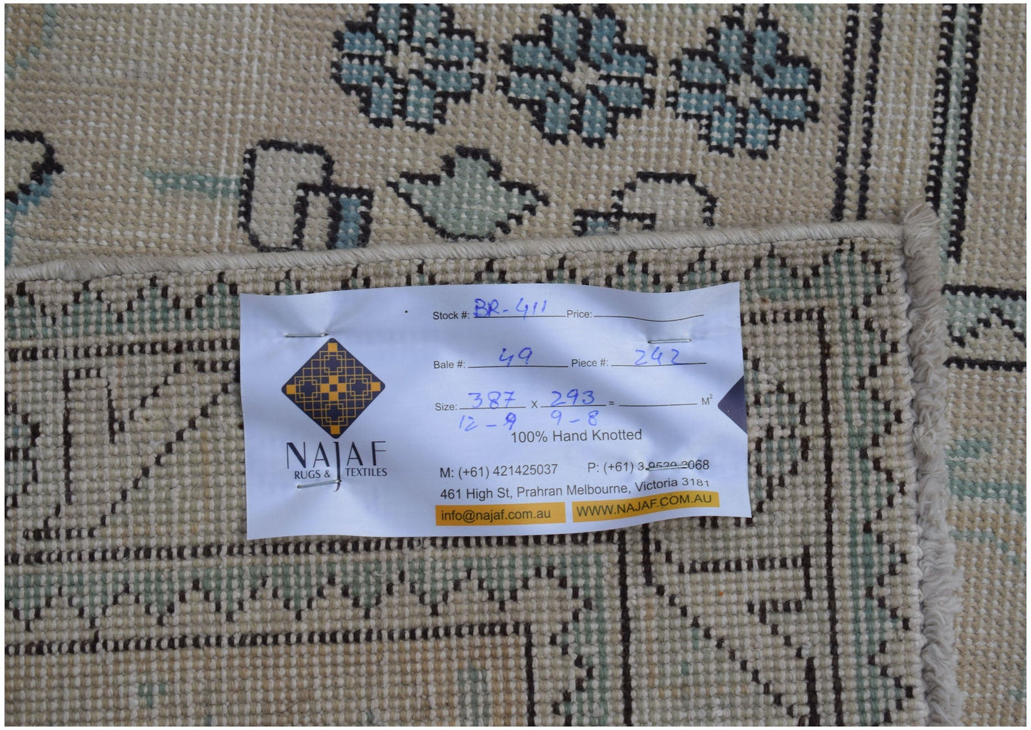 A vintage Persian Kerman rug featuring a detailed floral pattern in soft blue and cream tones.