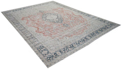 A vintage Persian Kerman rug featuring a central medallion and floral motifs in muted tones.