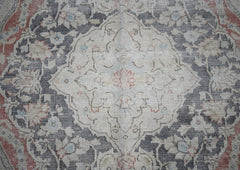 A vintage Persian Kerman rug featuring a central medallion surrounded by intricate floral patterns.