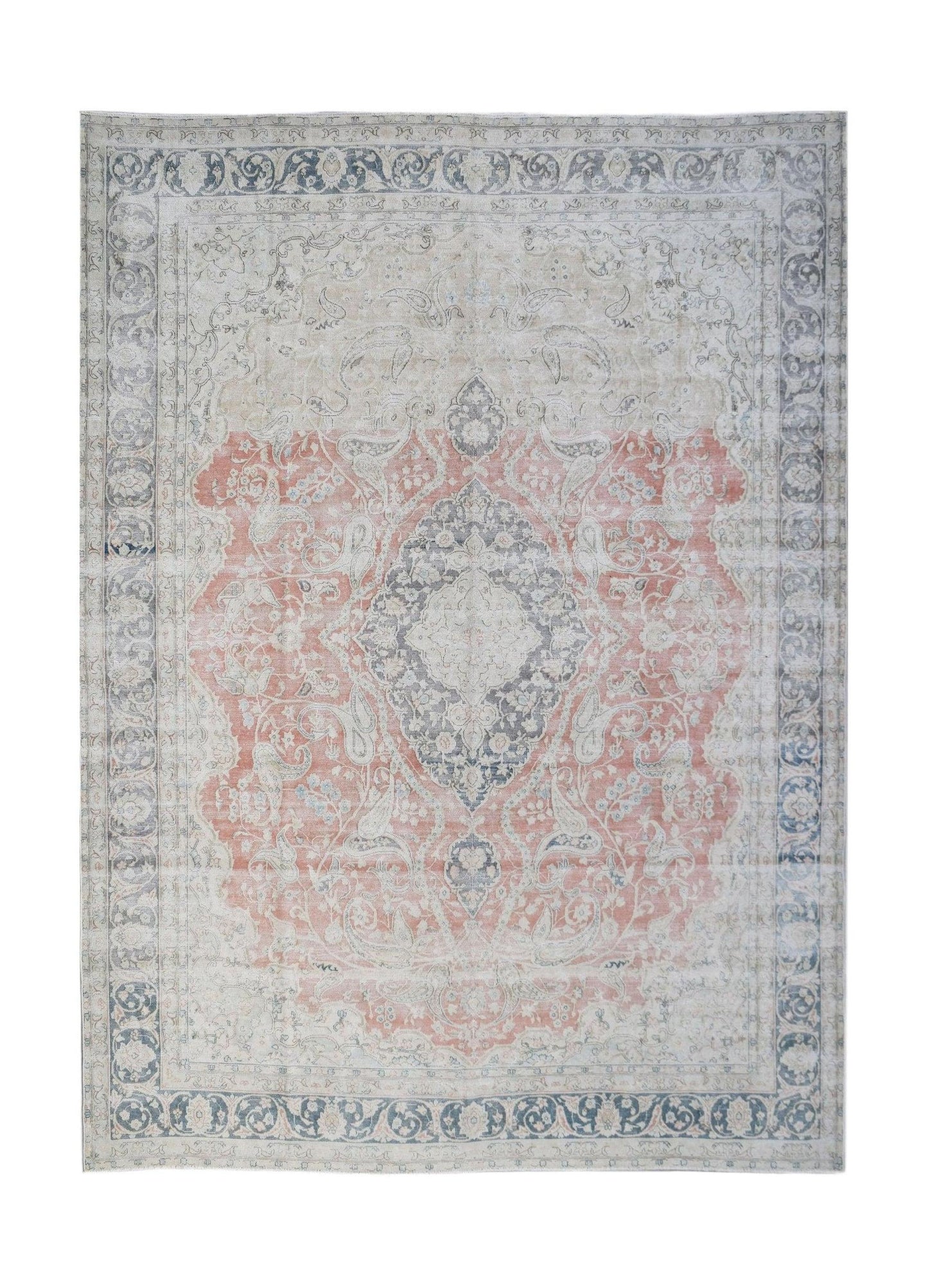 A vintage Persian Kerman rug featuring a central medallion and floral motifs in muted tones.