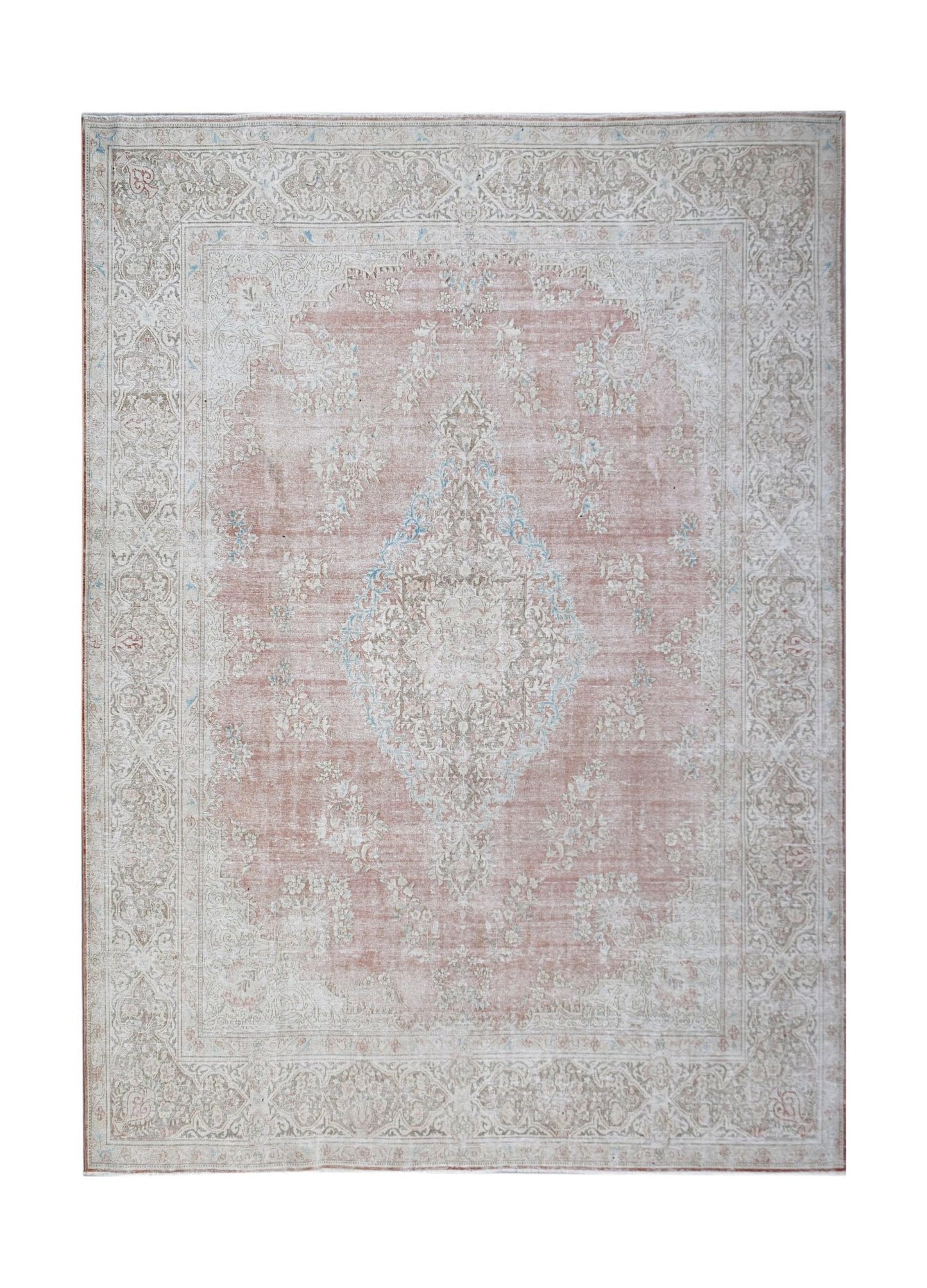 A vintage Persian Kerman rug featuring a central medallion and intricate floral patterns in pink.