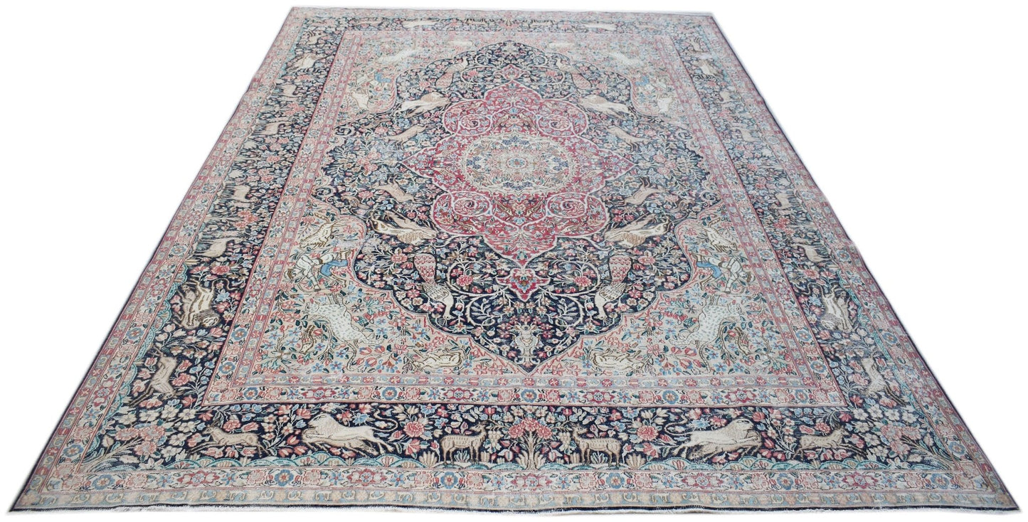 A vintage Persian Kerman rug featuring a central medallion and intricate floral animal motifs.