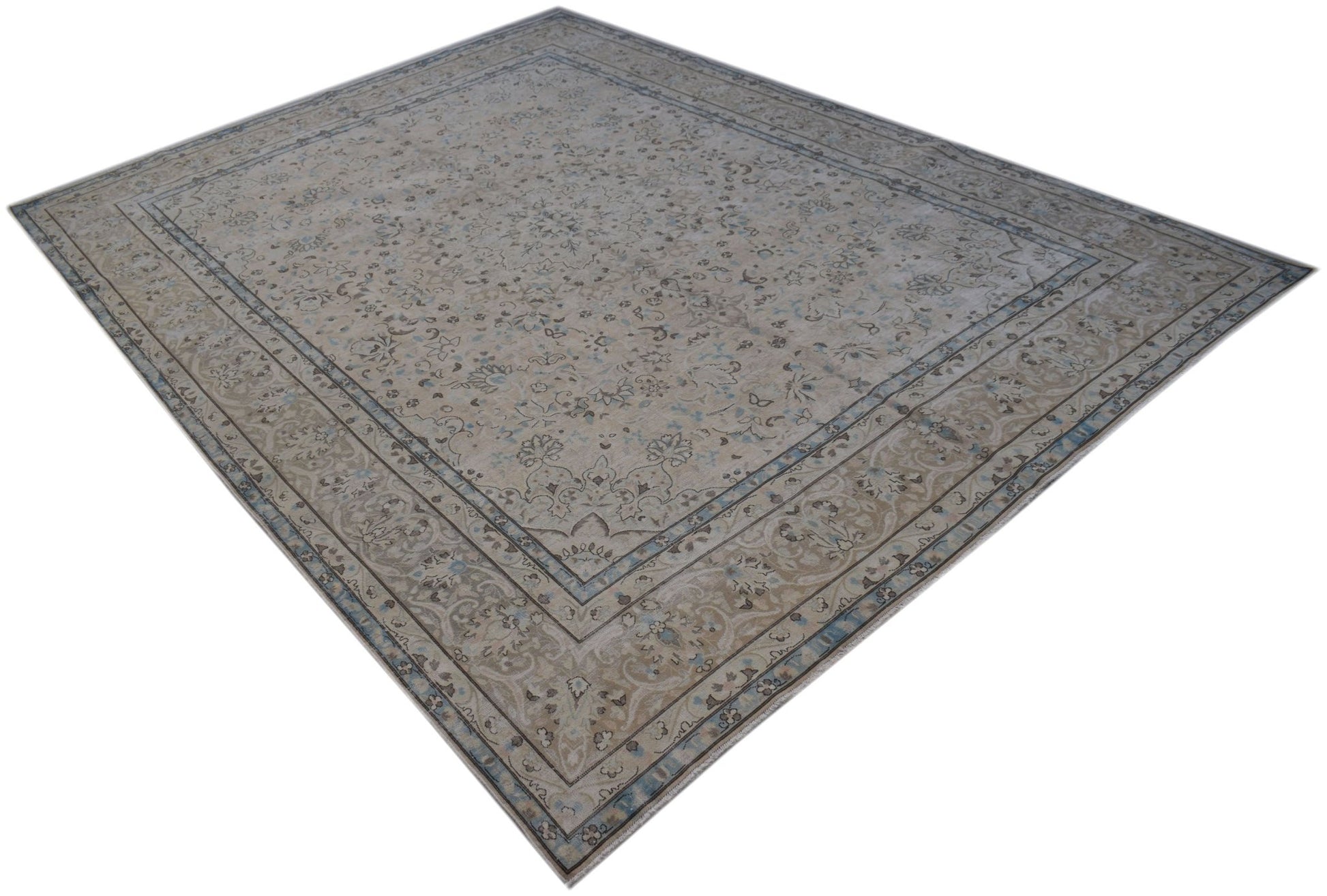 A vintage Persian Kerman rug featuring an intricate floral medallion design in soft neutral tones.
