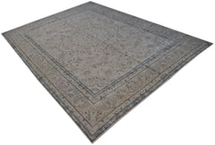 A vintage Persian Kerman rug featuring an intricate floral medallion design in soft neutral tones.