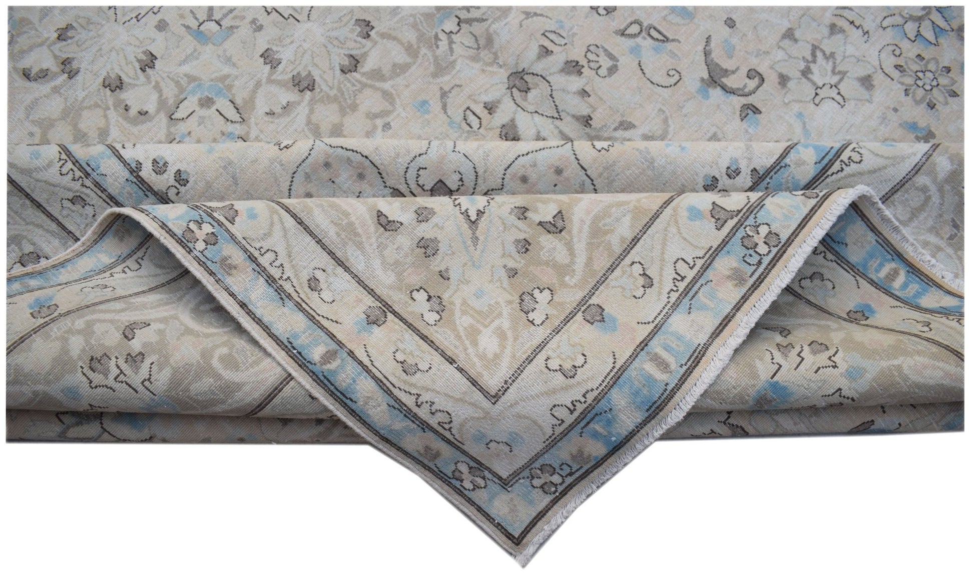 A vintage Persian Kerman rug featuring a floral medallion design in soft blue and beige tones.
