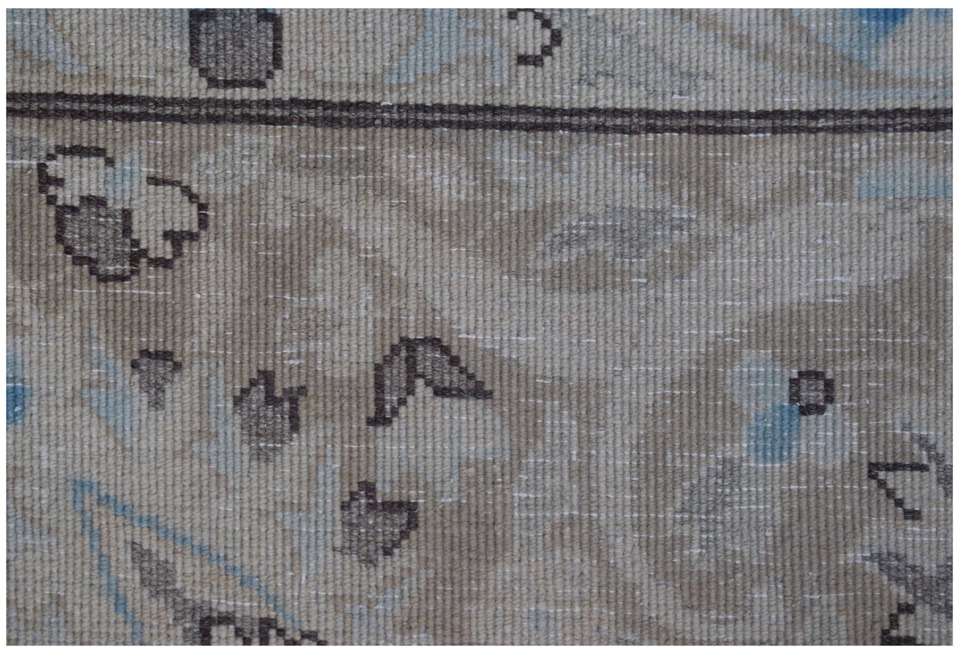 Close-up of a vintage Persian Kerman rug featuring intricate floral motifs in soft neutral tones.