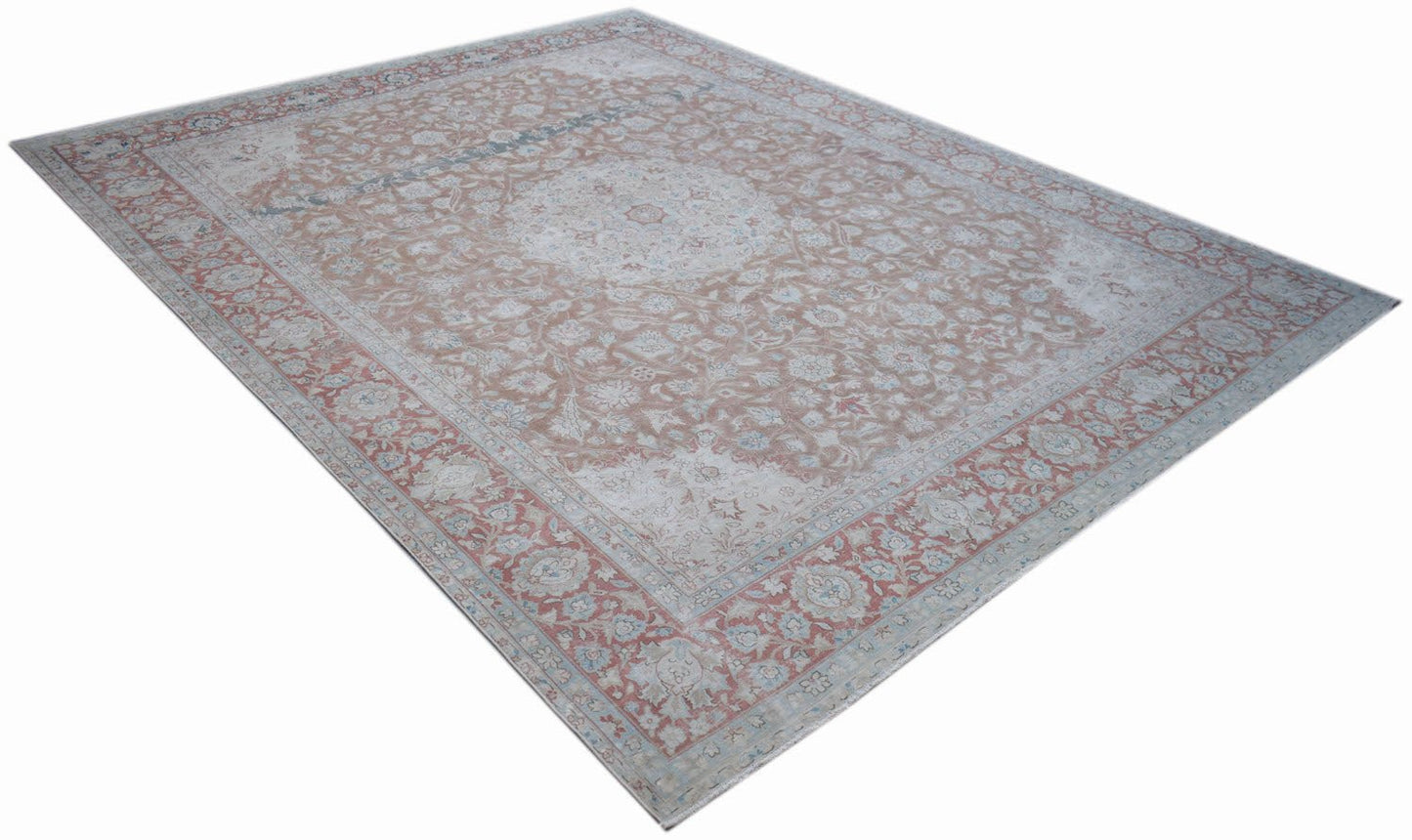 A vintage Persian Kerman rug featuring a central medallion and intricate floral patterns.