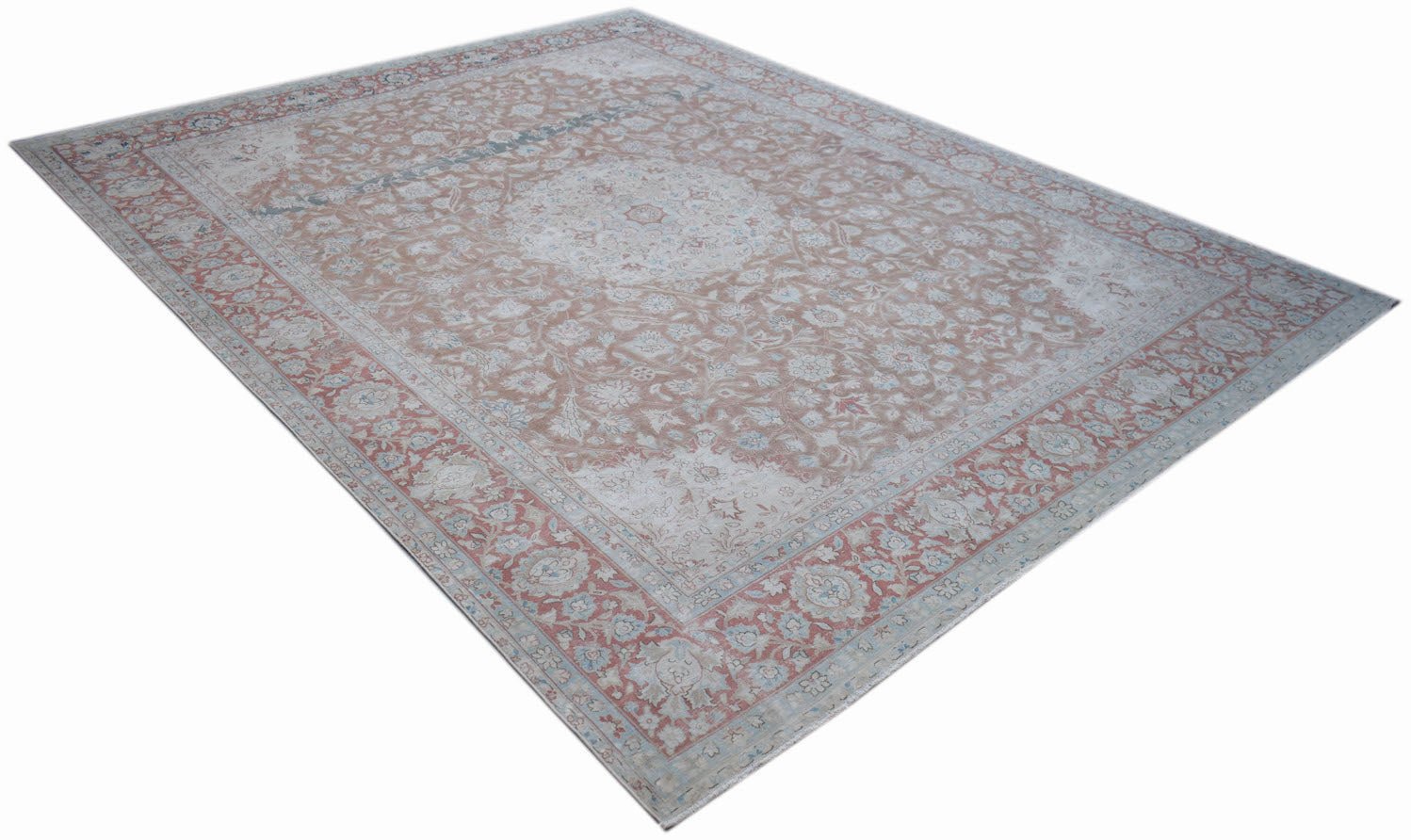A vintage Persian Kerman rug featuring a central medallion and intricate floral patterns.