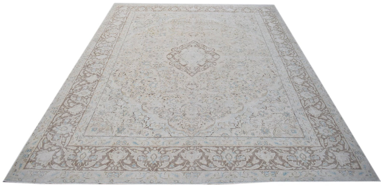 A vintage Persian Kerman rug featuring a central medallion and intricate floral patterns.