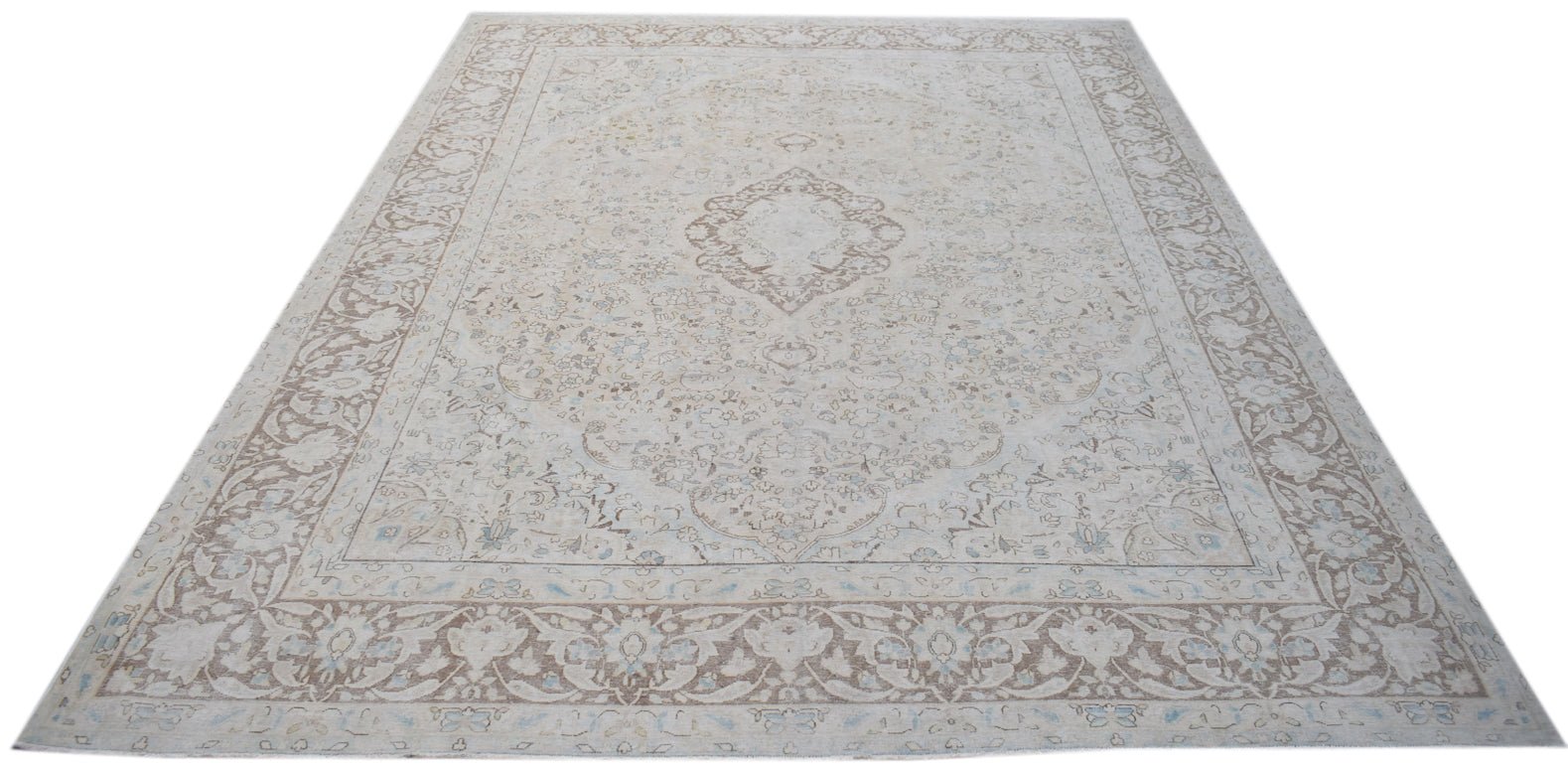 A vintage Persian Kerman rug featuring a central medallion and intricate floral patterns.