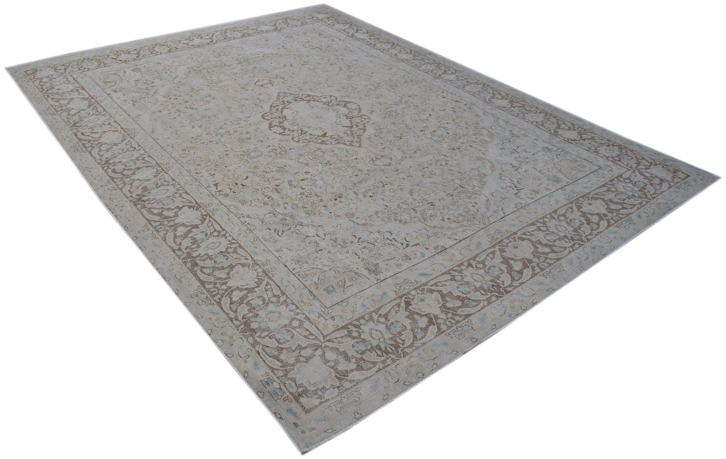 A vintage Persian Kerman rug featuring a central medallion and intricate floral border patterns.