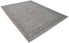 A vintage Persian Kerman rug featuring a central medallion and intricate floral border patterns.