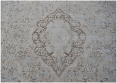 A vintage Persian Kerman rug featuring a central medallion surrounded by intricate floral patterns.