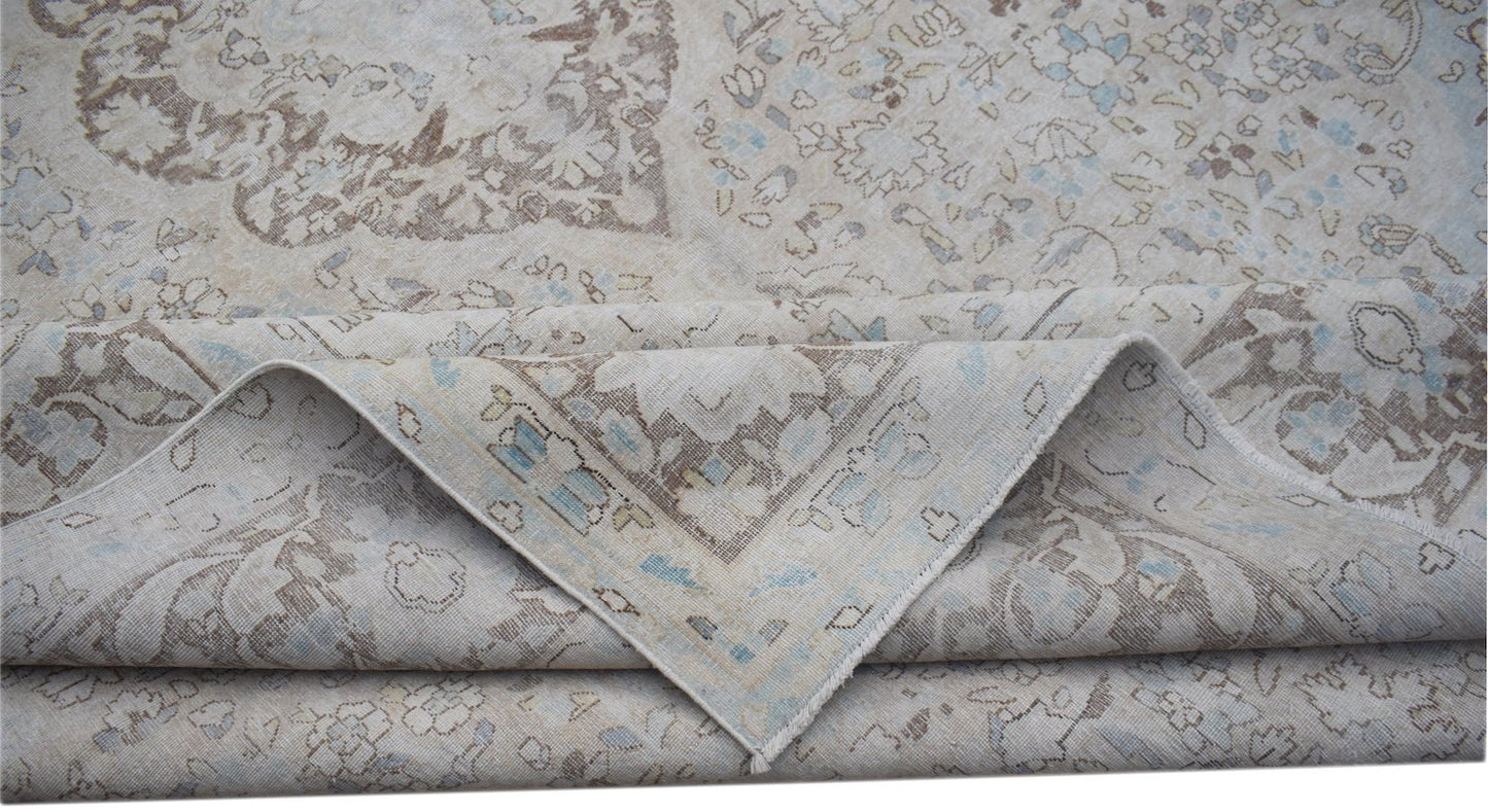 A vintage Persian Kerman rug featuring a soft-toned floral medallion design.