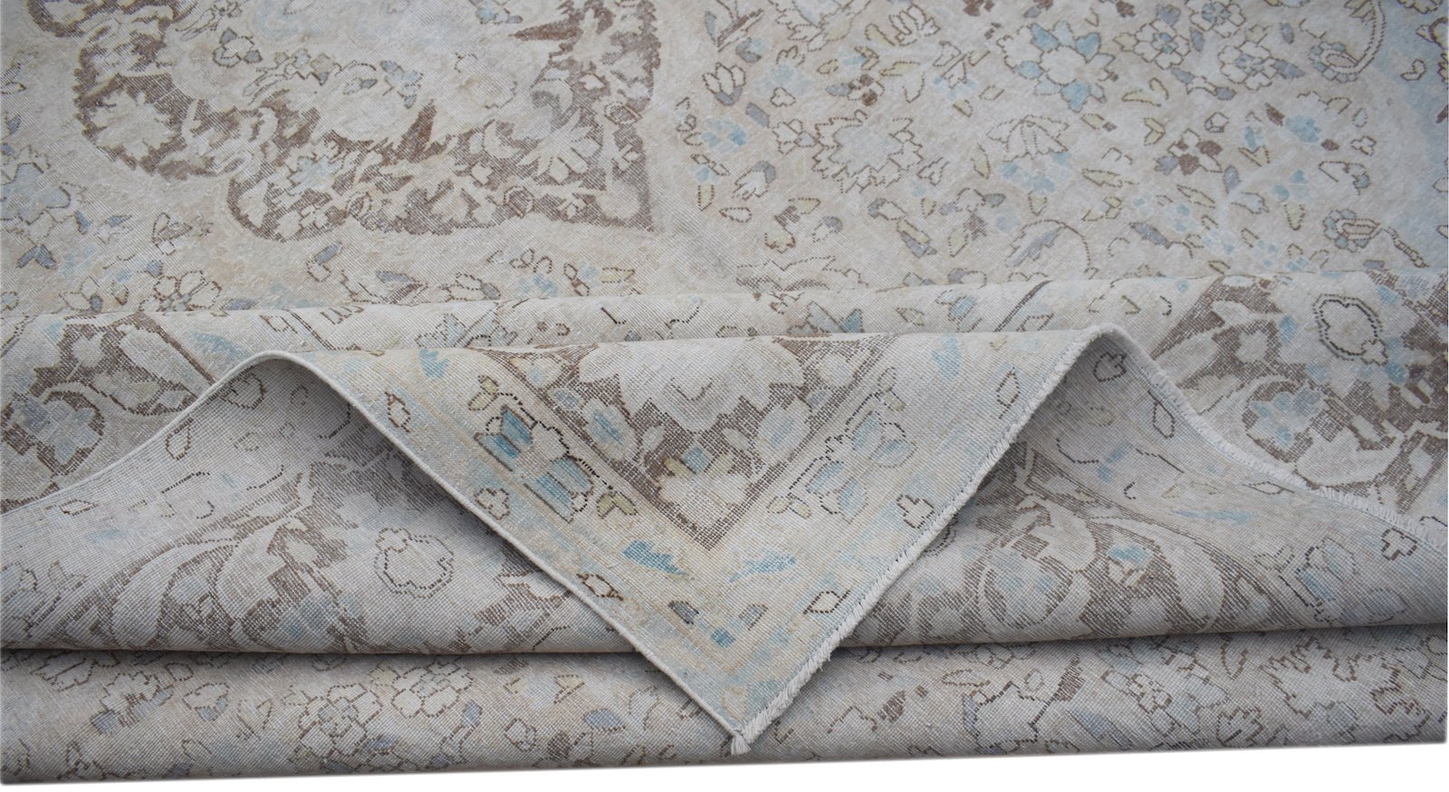 A vintage Persian Kerman rug featuring a soft-toned floral medallion design.