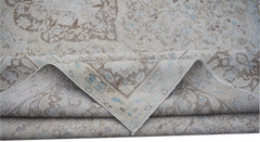 A vintage Persian Kerman rug featuring a soft-toned floral medallion design.