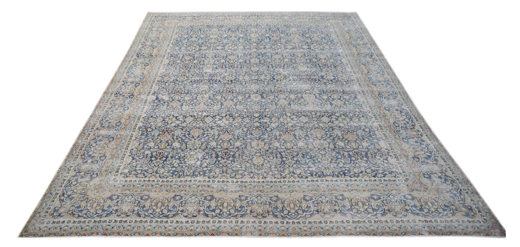 A vintage Persian Kerman rug featuring an intricate blue and cream floral medallion design.