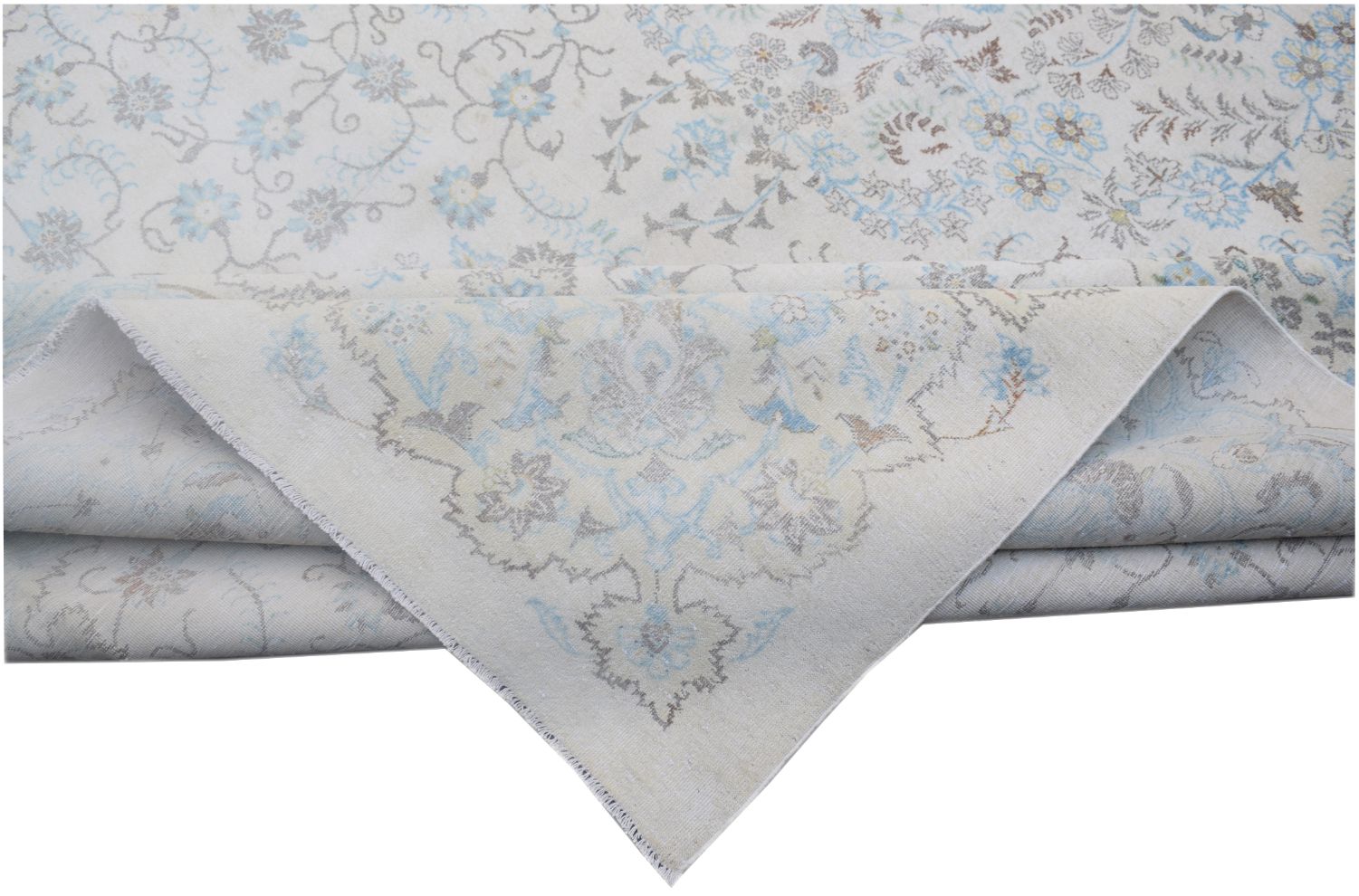 A vintage Persian Kerman rug featuring a light cream background with intricate blue floral patterns.