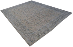A vintage Persian Kerman rug featuring an intricate floral pattern in soft blue and beige tones.