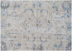 A vintage Persian Kerman rug featuring a faded floral medallion pattern in blue and beige tones.