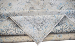 A vintage Persian Kerman rug featuring a light beige field with intricate blue floral patterns.