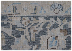 A close-up of a vintage Persian Kerman rug featuring intricate floral patterns in blue and beige.