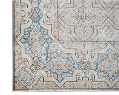 Vintage Persian Kerman rug featuring a beige field with intricate blue and pink floral motifs.