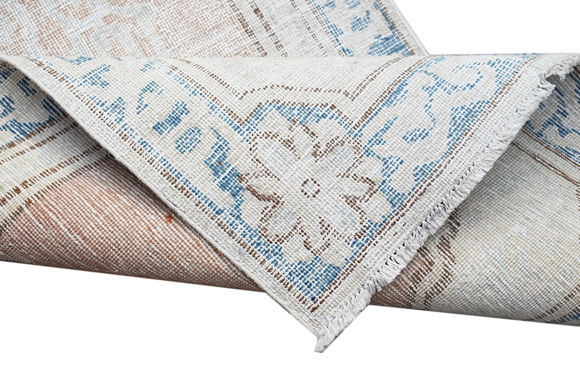 A vintage Persian Kerman runner featuring a blue and beige floral medallion pattern.
