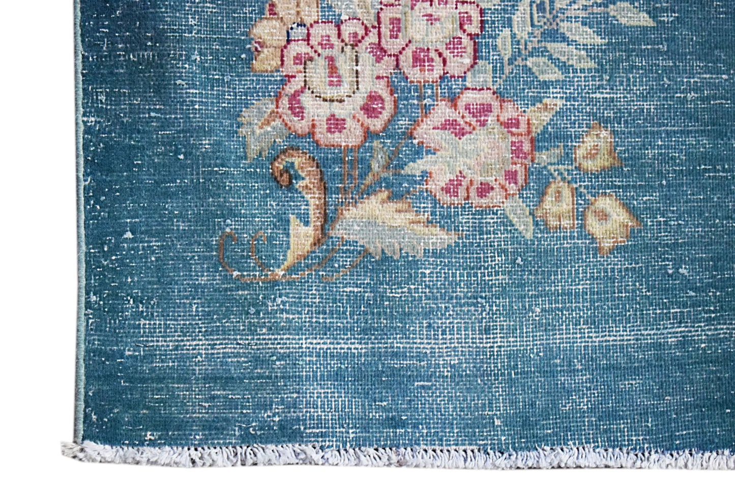 A vintage Persian Kerman runner featuring intricate floral motifs on a blue field.