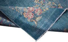 A vintage Persian Kerman runner featuring a blue field with intricate floral patterns.