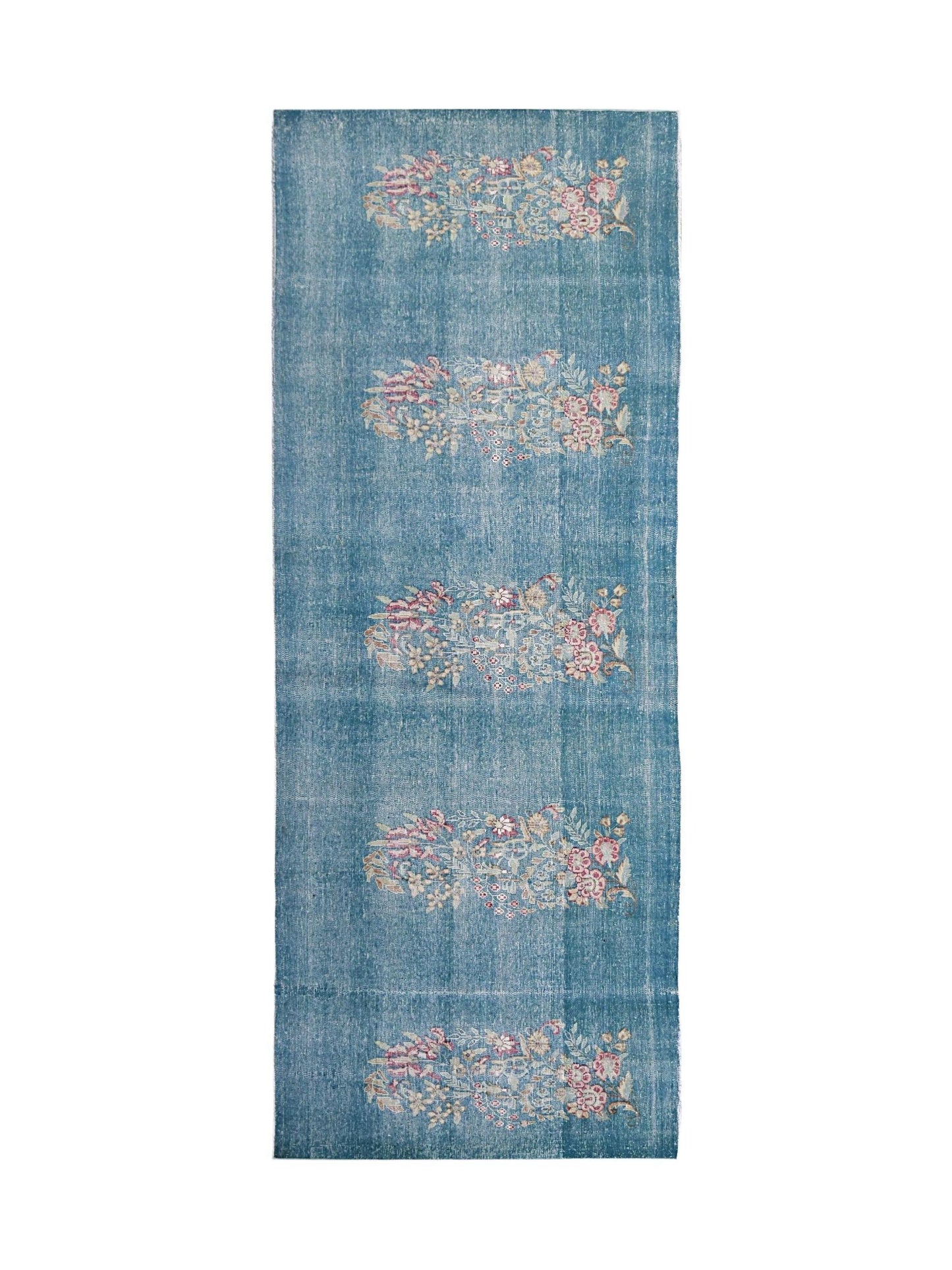 A vintage Persian Kerman runner featuring repeating floral motifs on a blue field.