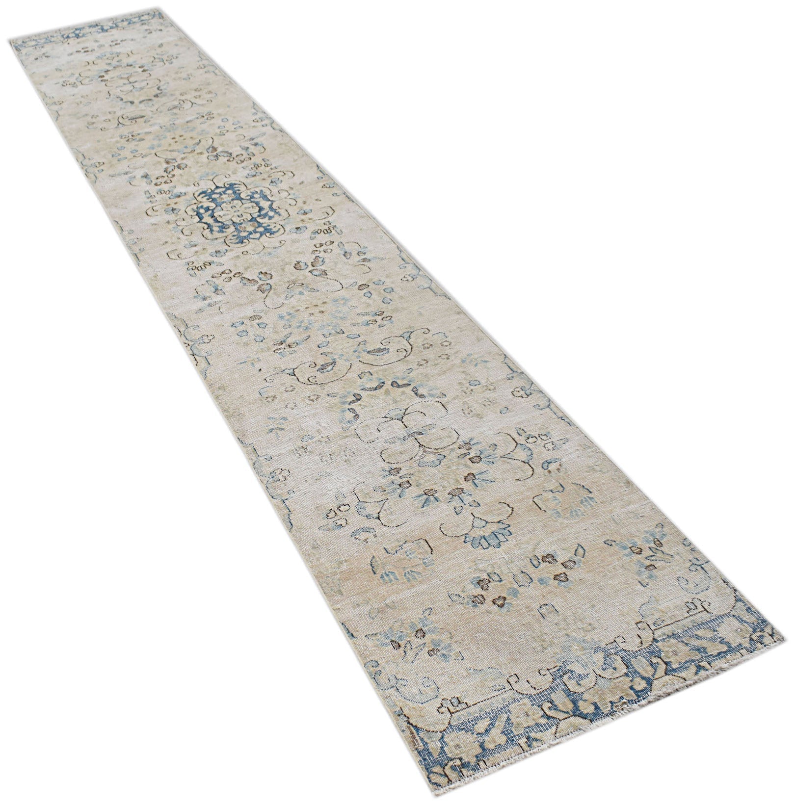 A vintage Persian Kerman runner rug featuring a beige field with blue floral and medallion motifs.