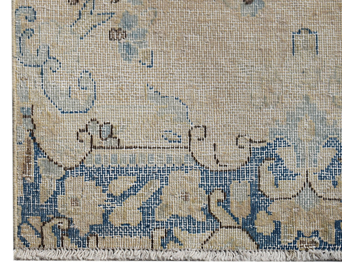 A vintage Persian Kerman runner featuring intricate blue floral patterns on a beige background.