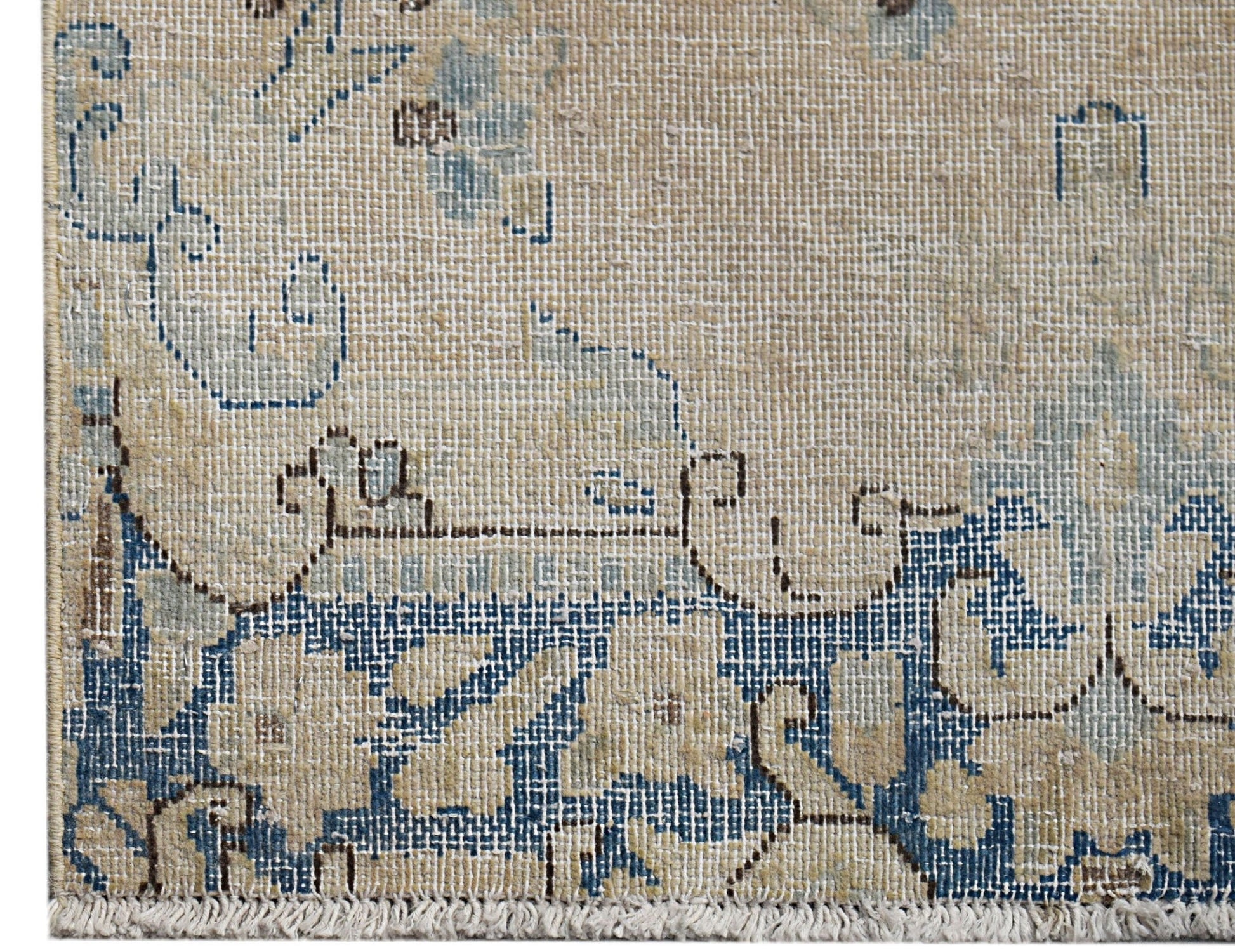 A vintage Persian Kerman runner featuring intricate blue floral patterns on a beige background.