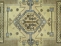 A vintage Persian rug featuring a central geometric medallion with floral motifs on a tan field.
