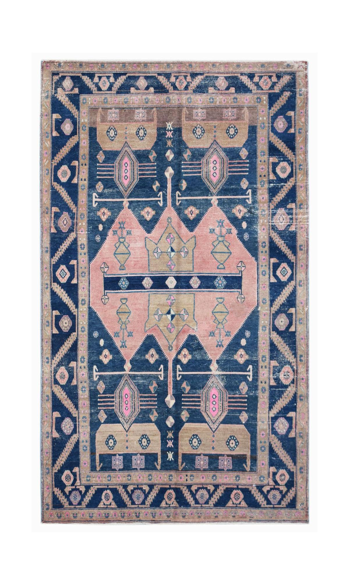 A vintage handwoven Persian Koliai rug featuring a geometric pink and blue medallion pattern.