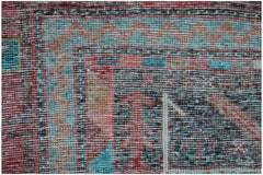 A close-up of a vintage Persian Koliai rug featuring a geometric Throne of Jamshed pattern.