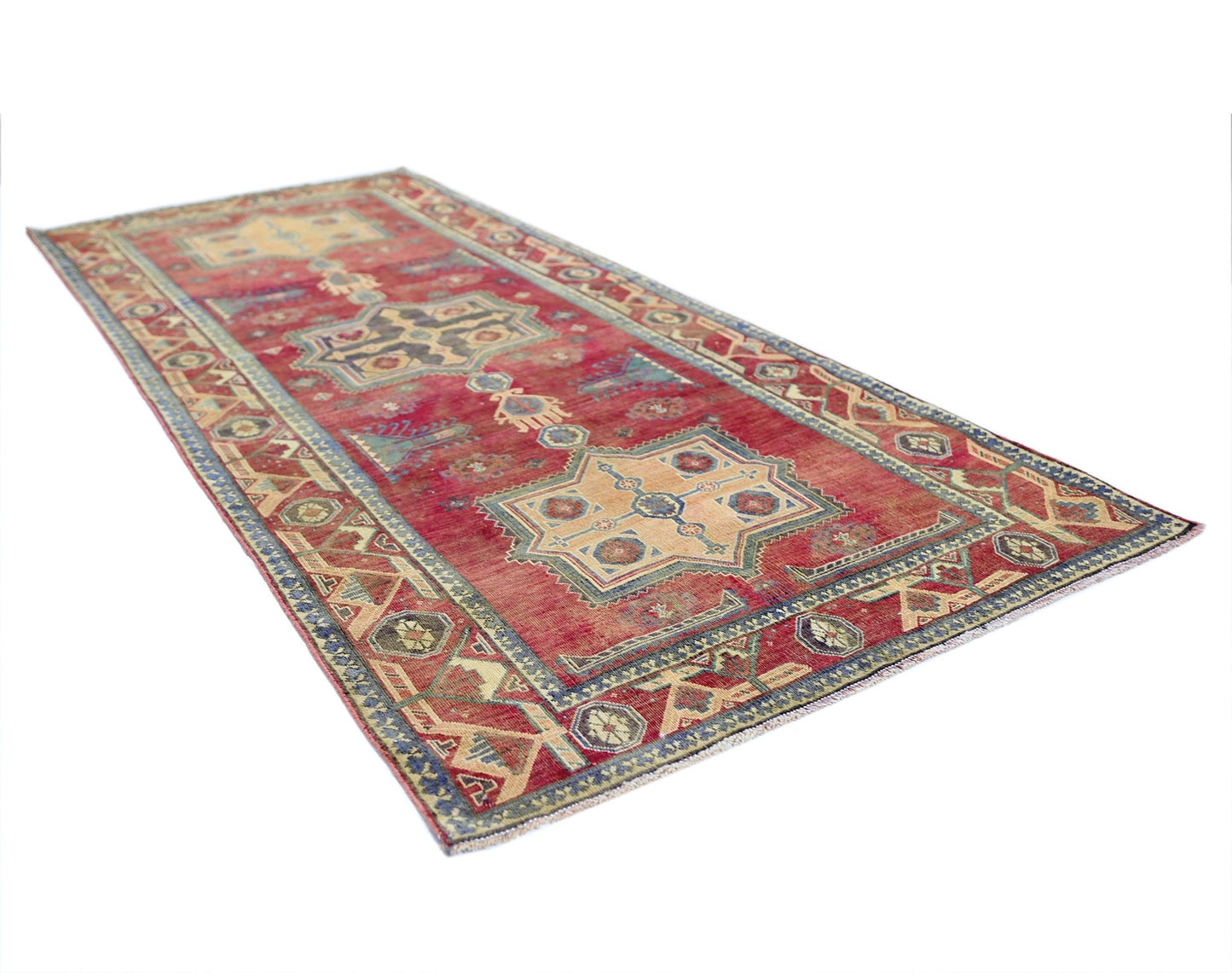 A rectangular vintage Persian rug featuring geometric patterns in red, blue, and beige tones.