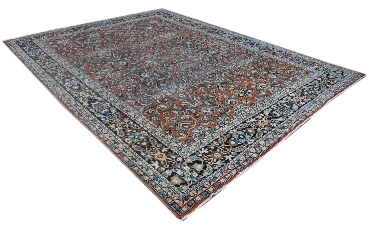 A vintage Persian Lori rug featuring an intricate floral pattern in rust, blue, and black tones.