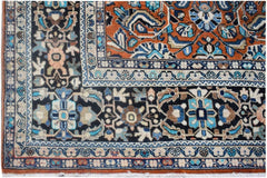 A vintage Persian Lori rug featuring intricate geometric and floral patterns in blue and orange.